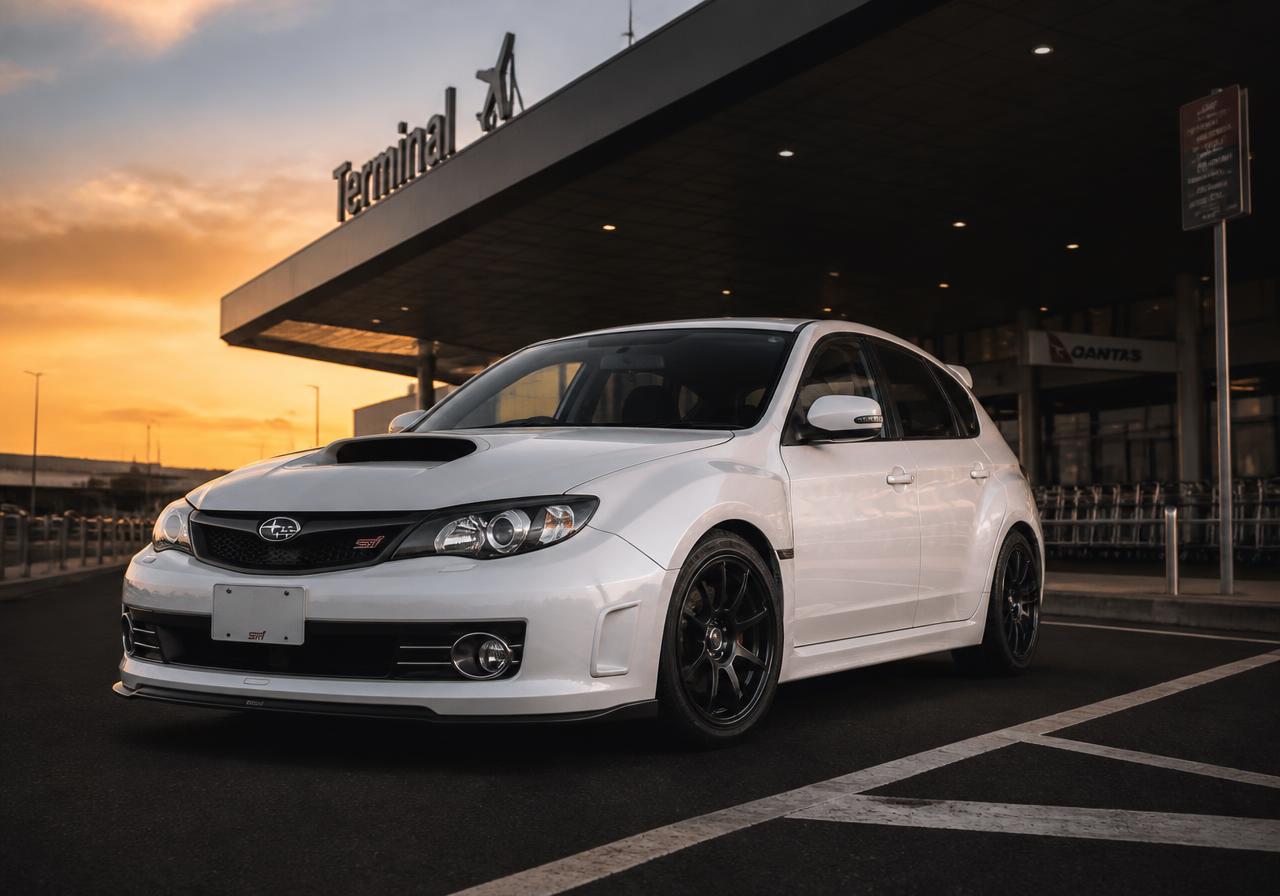 White Subaru Impreza used by Road Runners Express by Angel, parked at the airport terminal